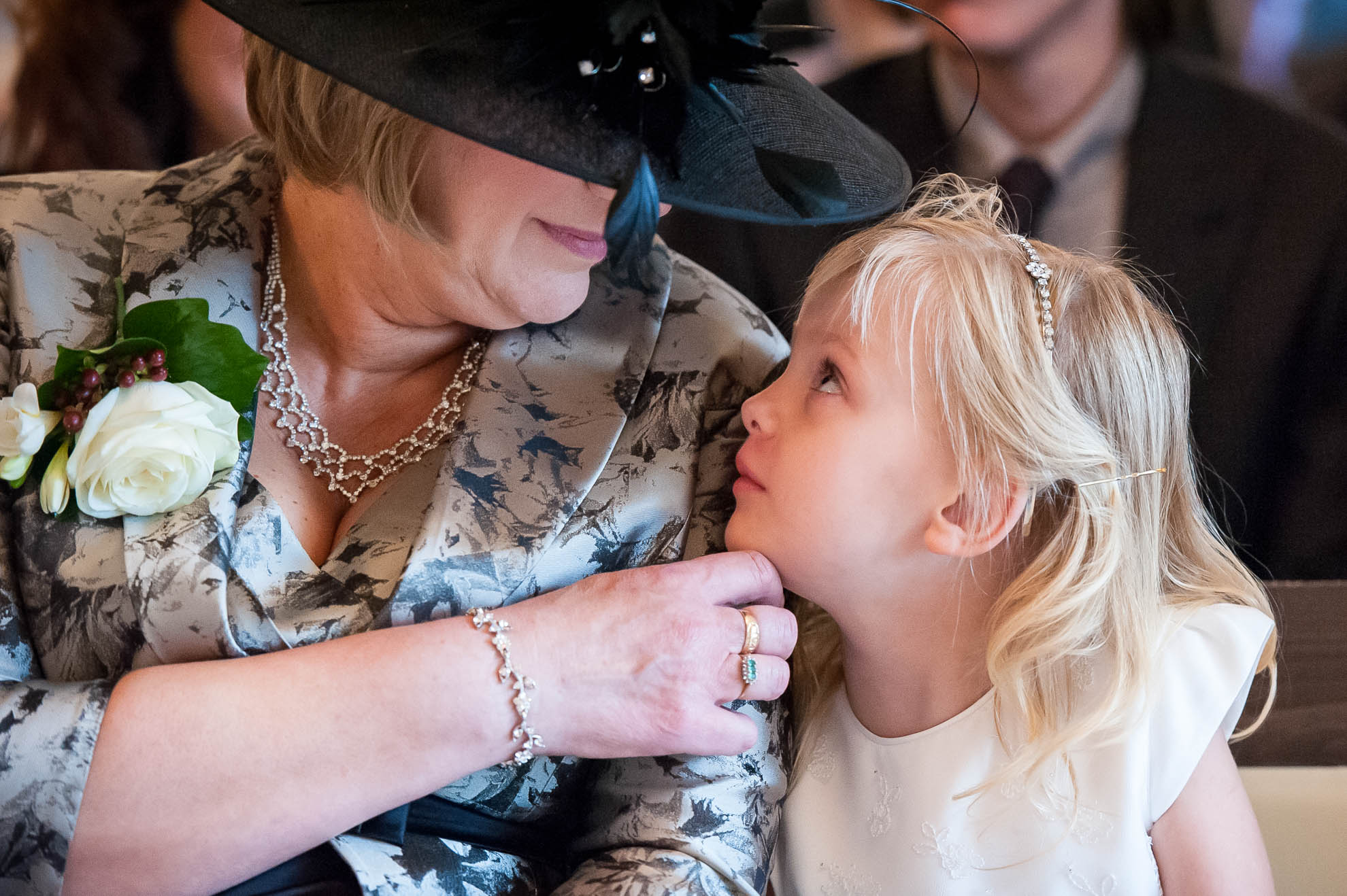 flower girl looks up at her grandmother