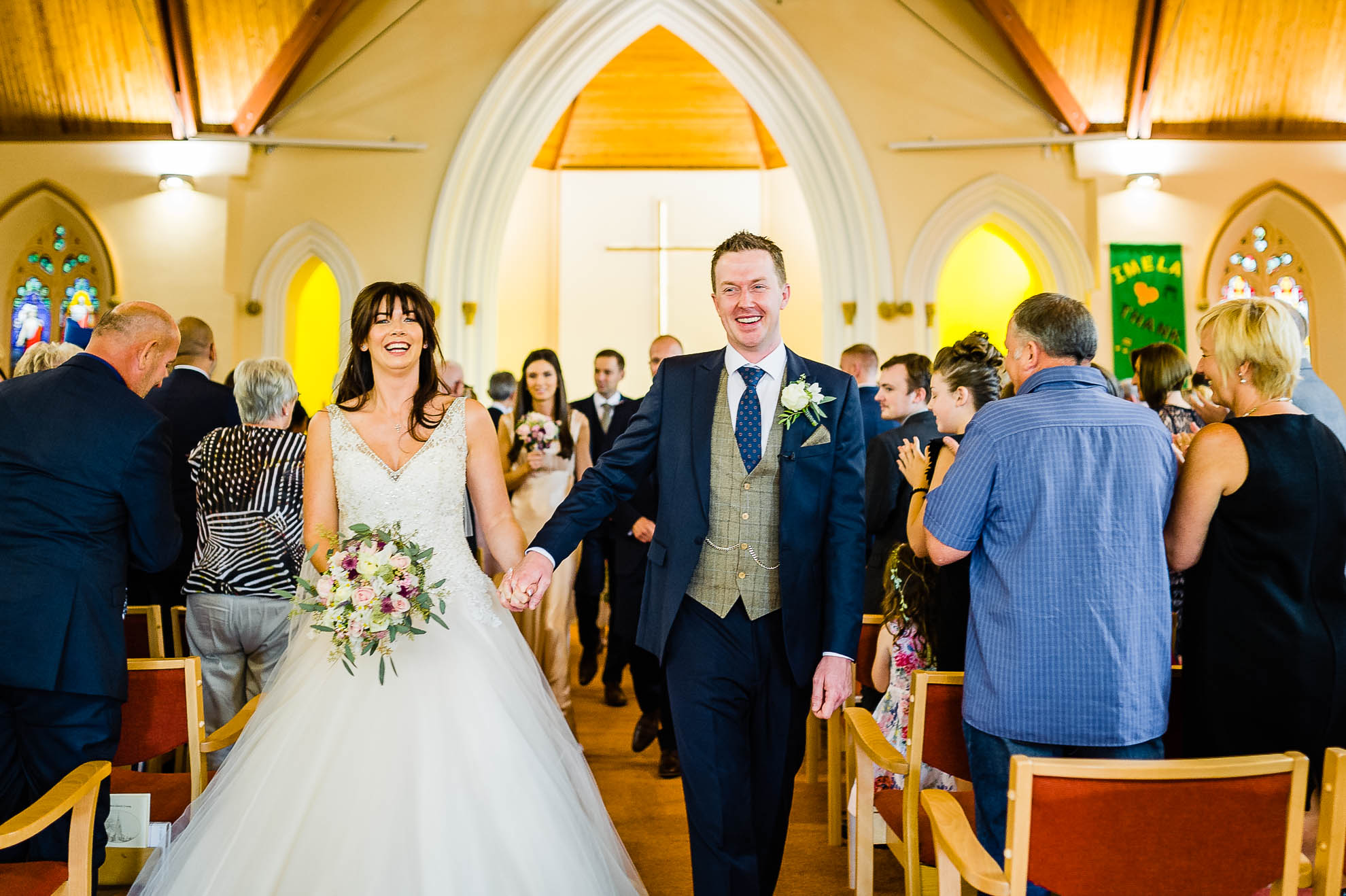 The bride and groom walk back down the aisle