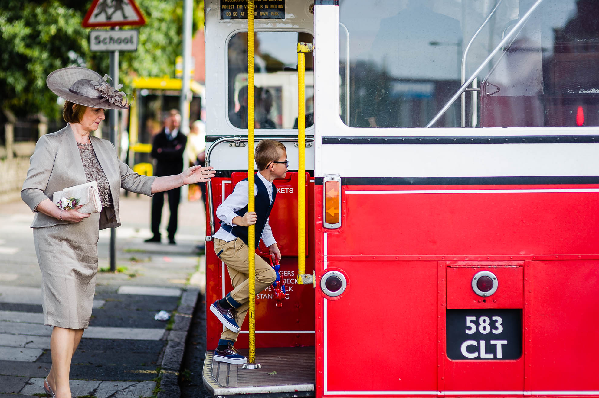 little boy gets on wedding bus