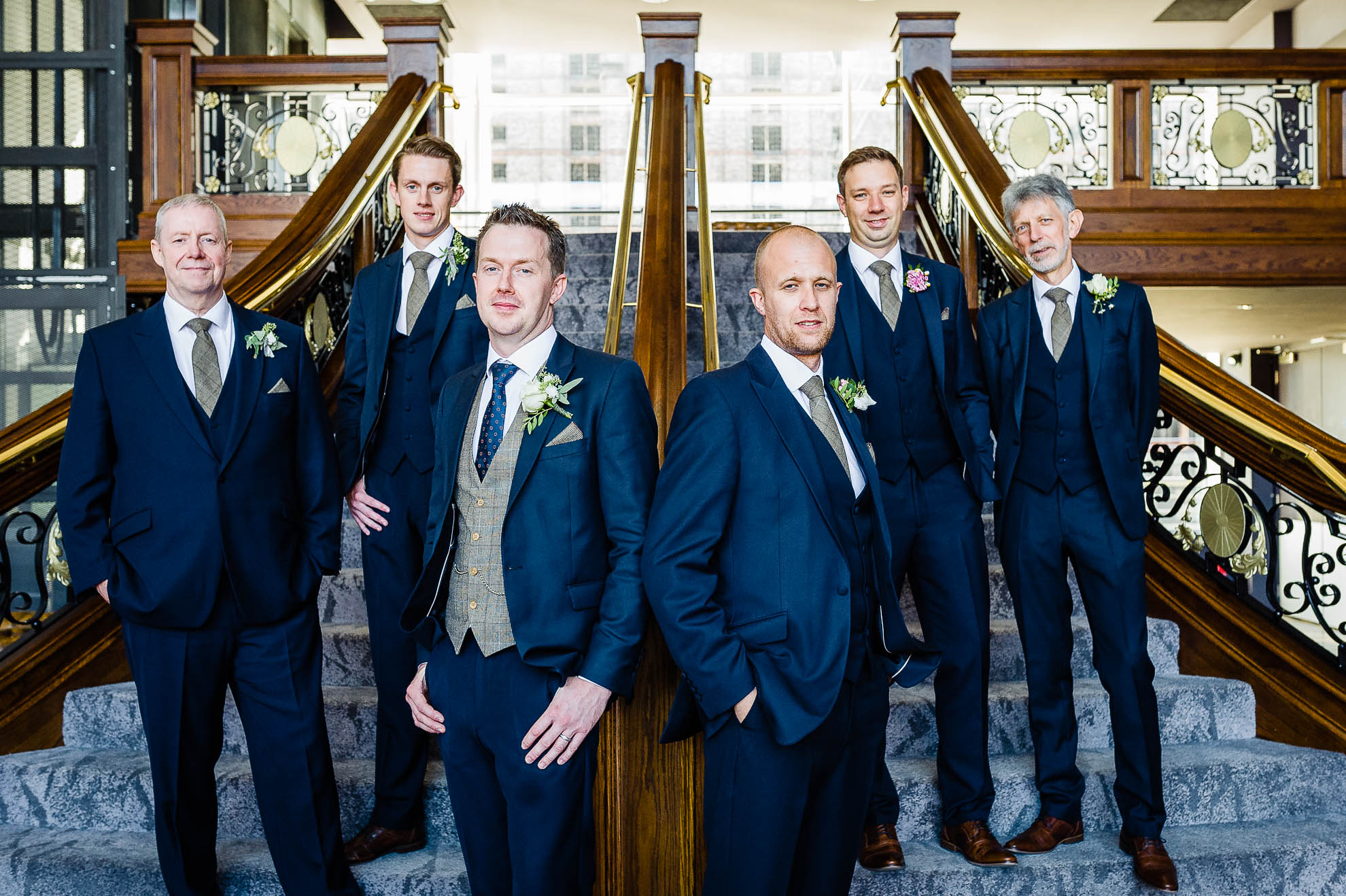 groom and his groomsmen group photograph on titanic staircase