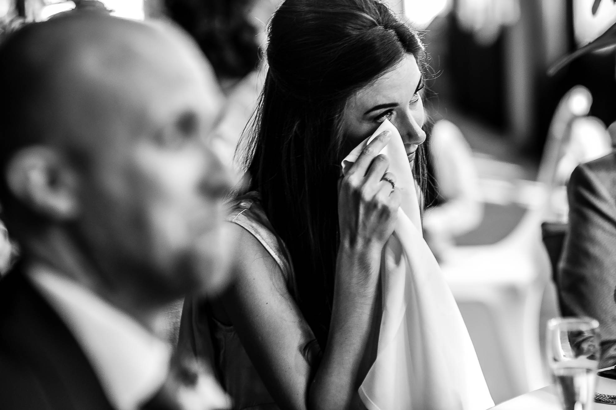 Bridesmaid sheds a tear during groom's speech