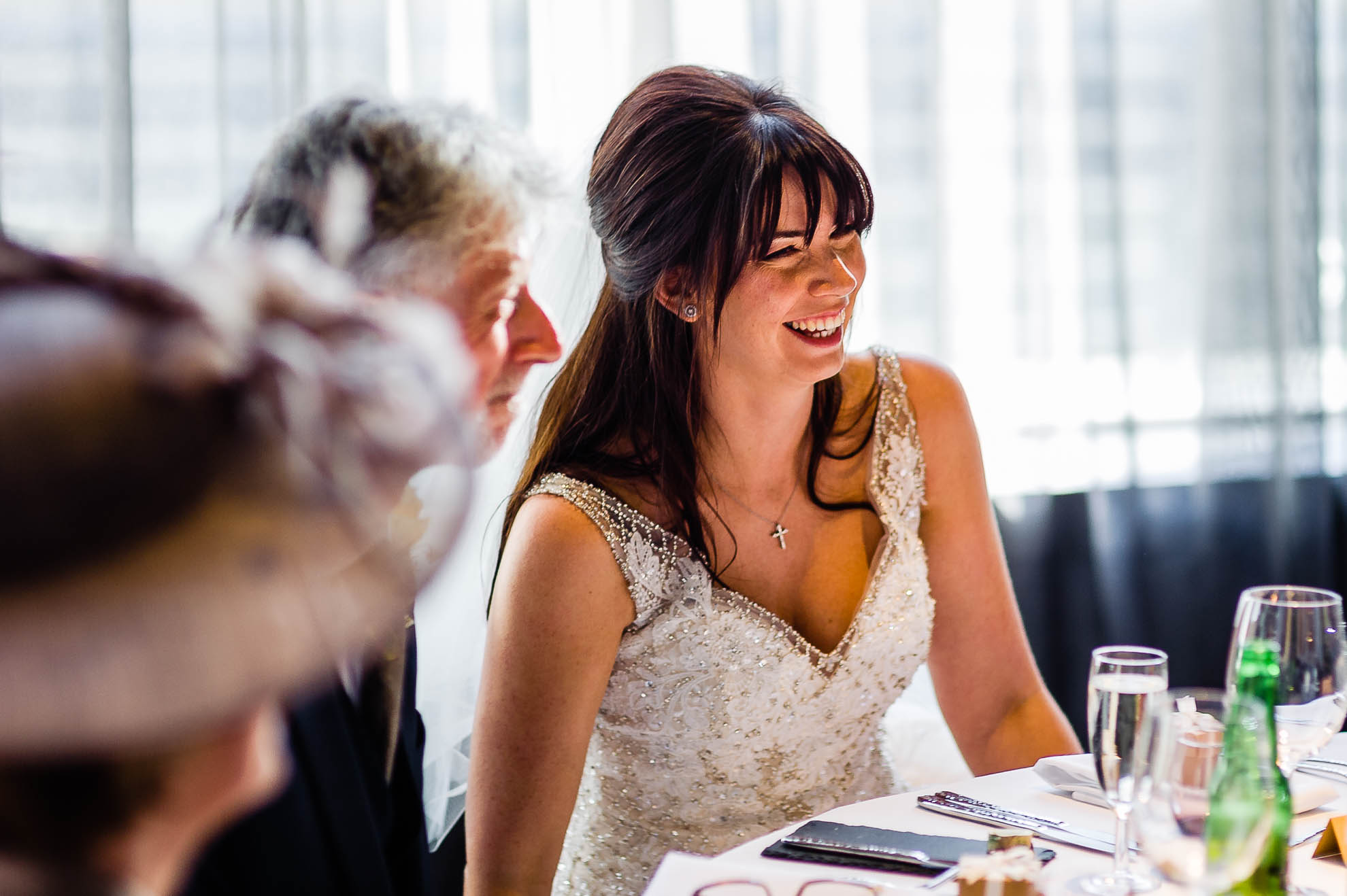 bride laughs during grooms speech
