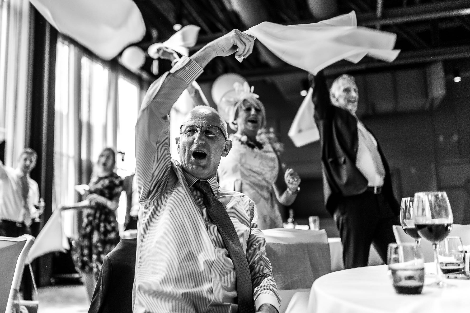 wedding guests wave napkins