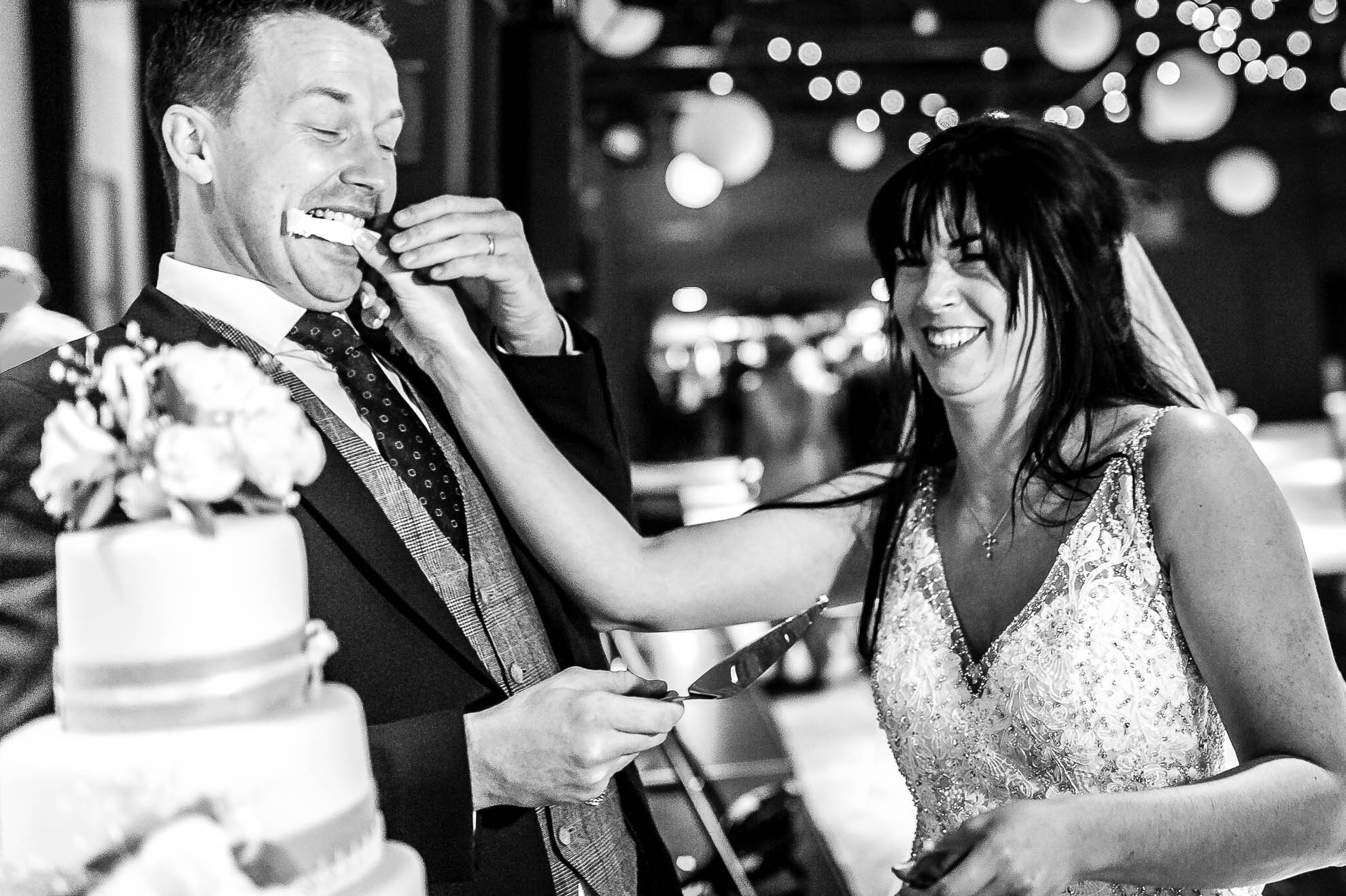 The bride feeds the groom wedding cake