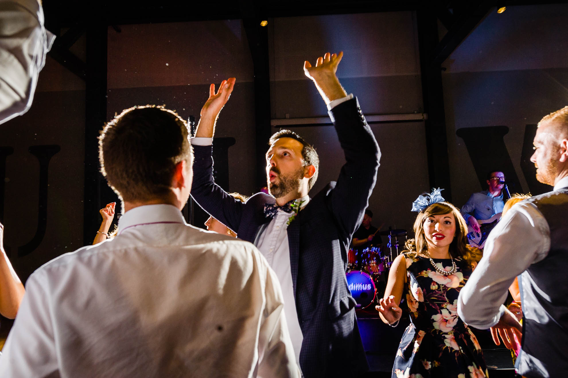a man holds his hands in the air while dancing