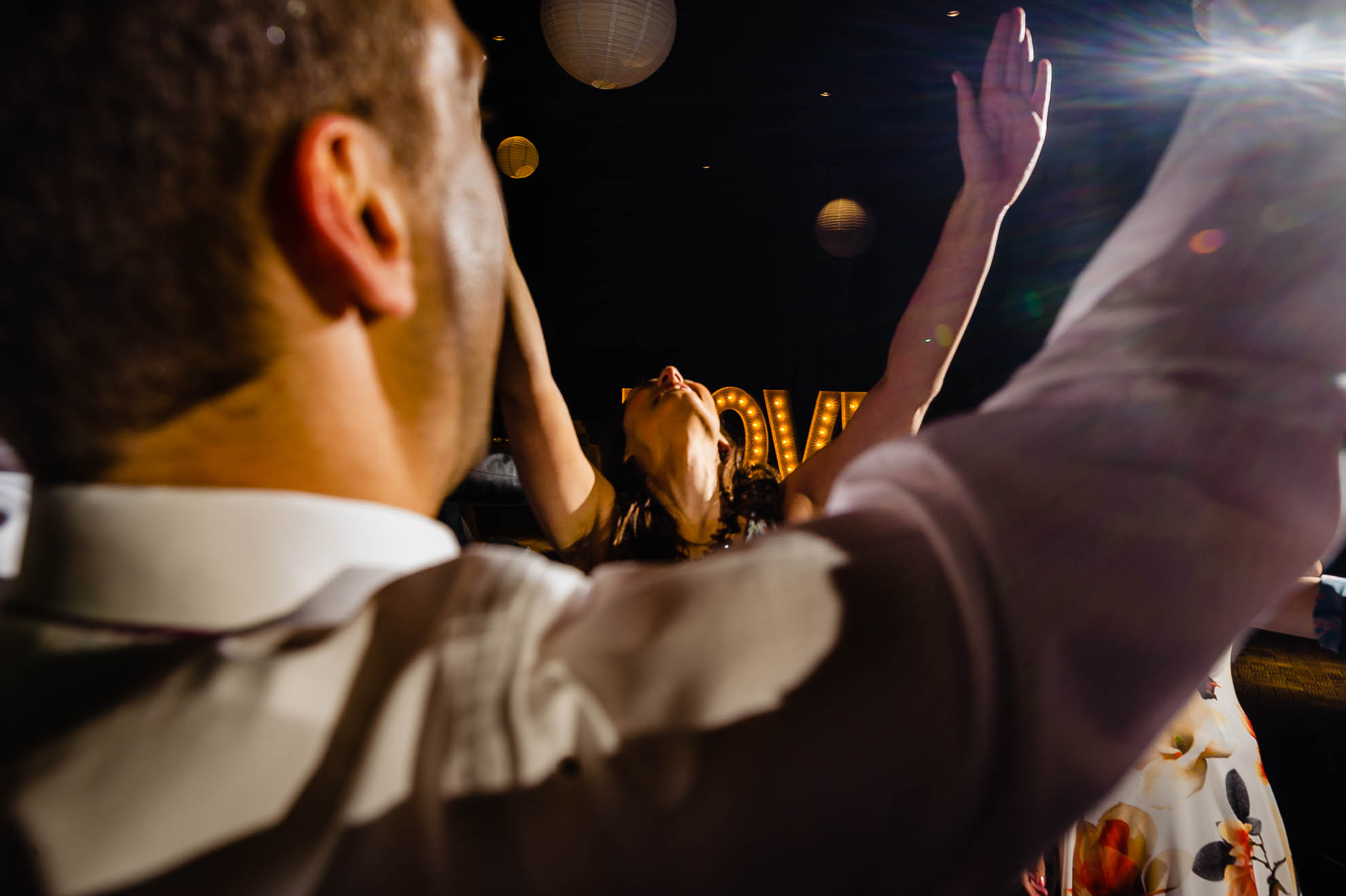 guest with hands in the air while dancing