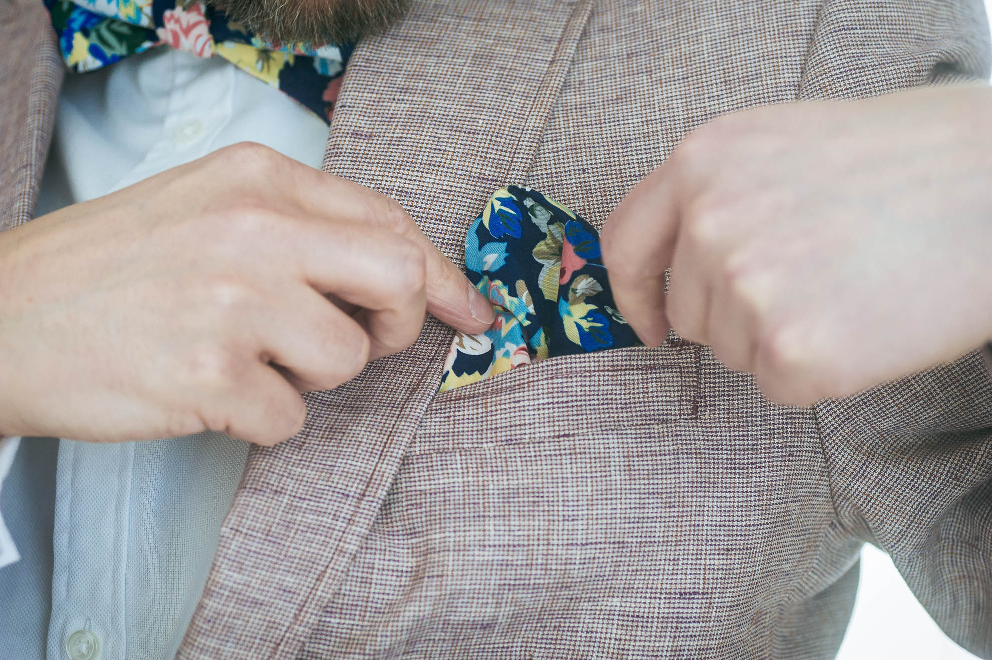 Luke fixes his kerchief on his wedding suit