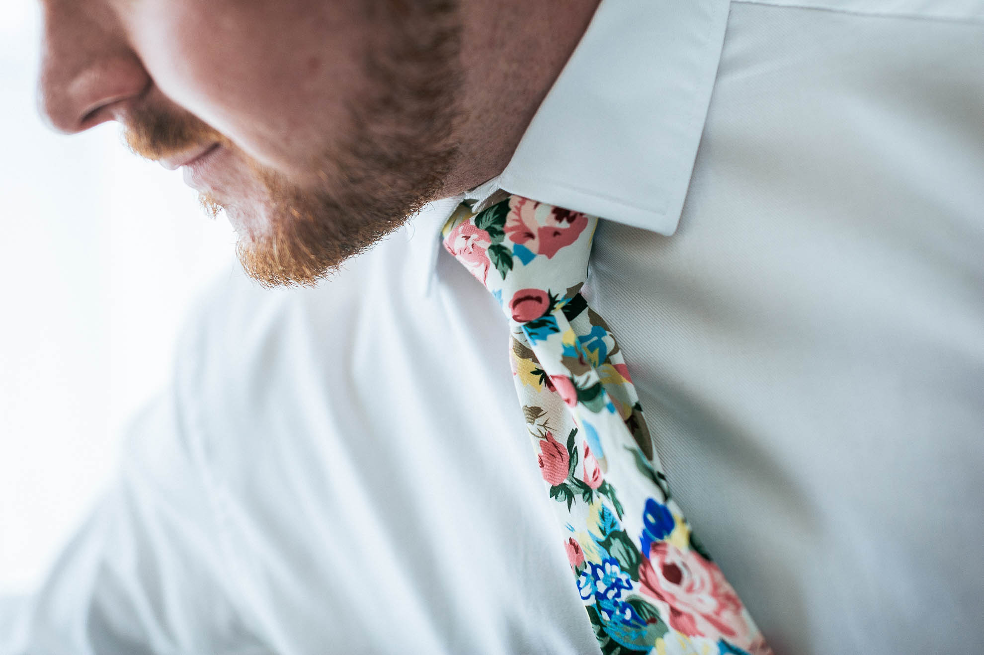 Mike adjusts his floral tie