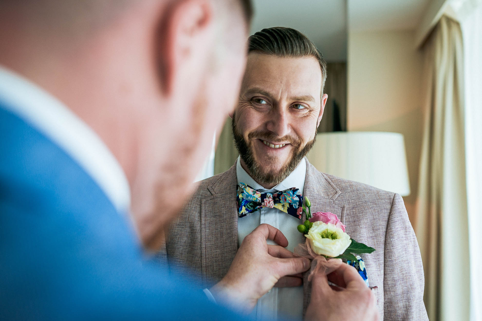 Mike puts on Luke's buttonhole flower