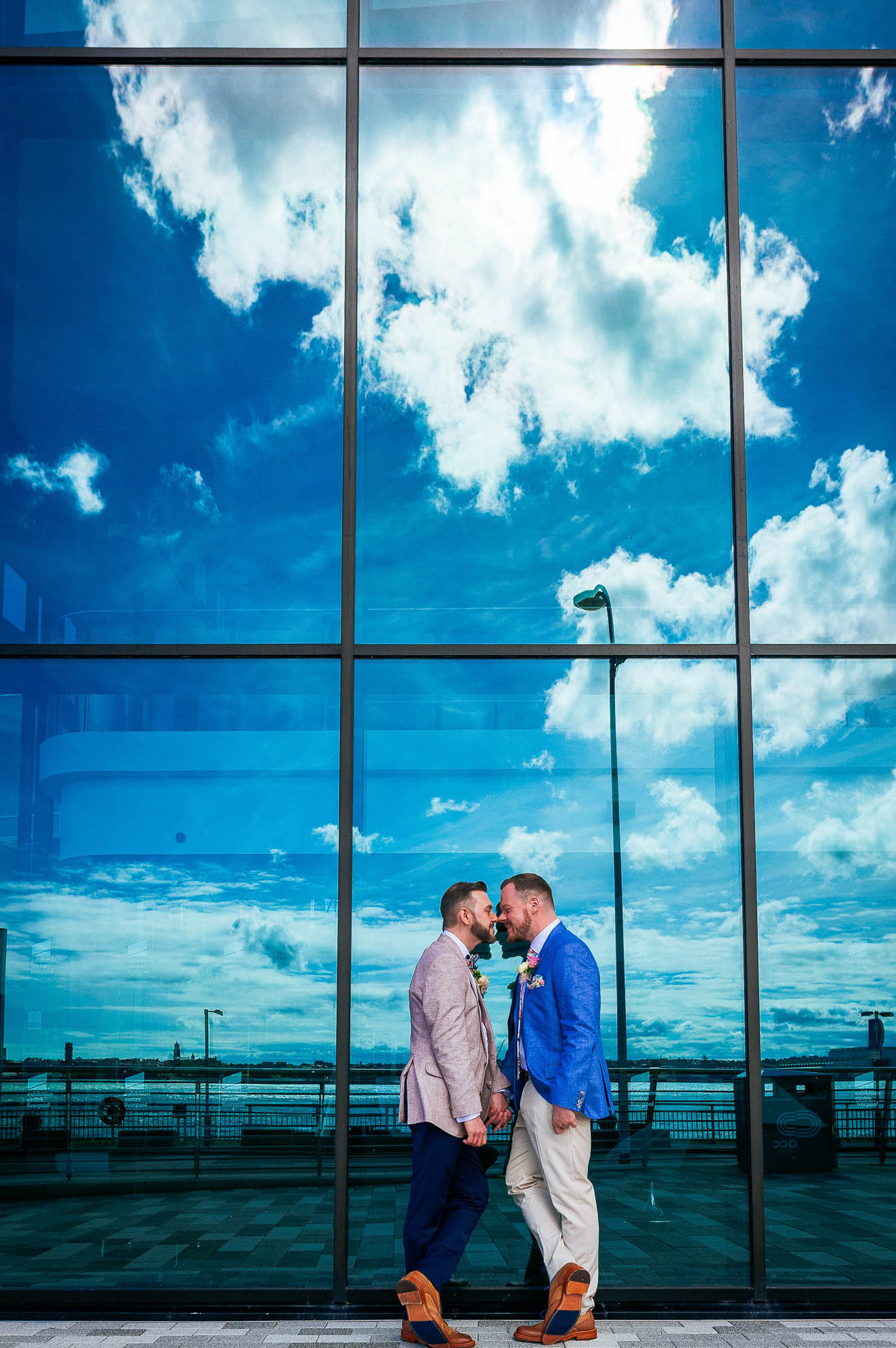 luke and mike share a moment with reflections of clouds in window
