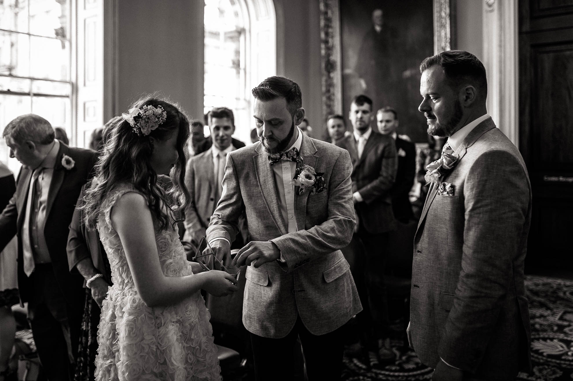 flower girl passes the rings to Luke