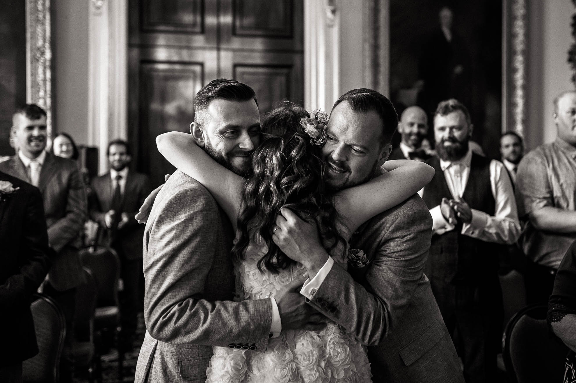 luke & mike give the flower girl a big hug
