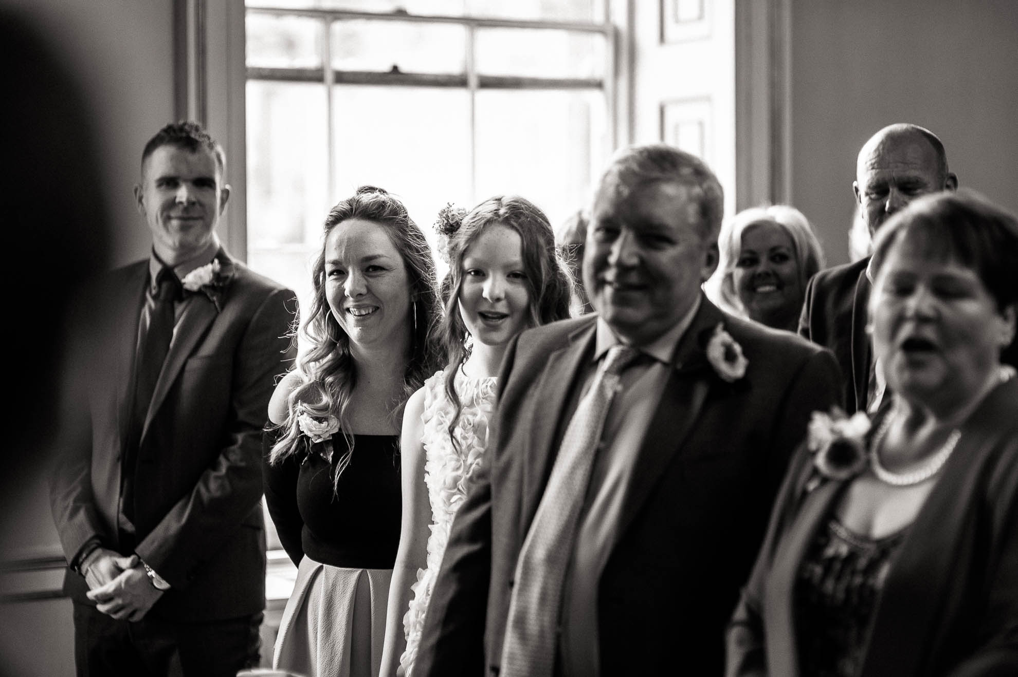 mikes family smile as they say their wedding vows