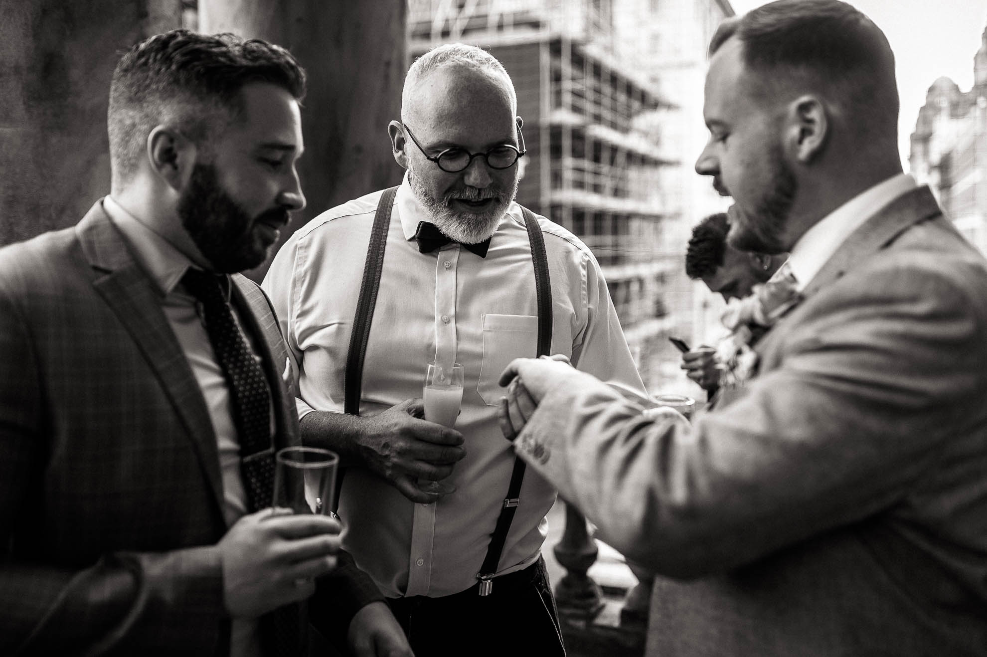 A guest admires Mike's wedding ring.