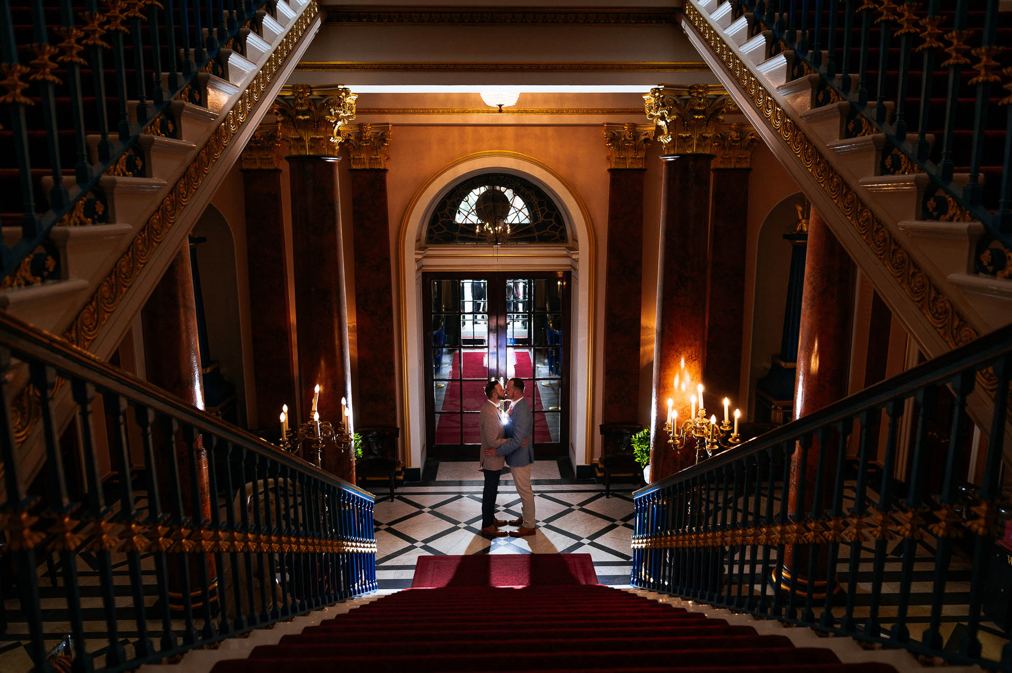luke and mike kiss at the bottom of the staircase 