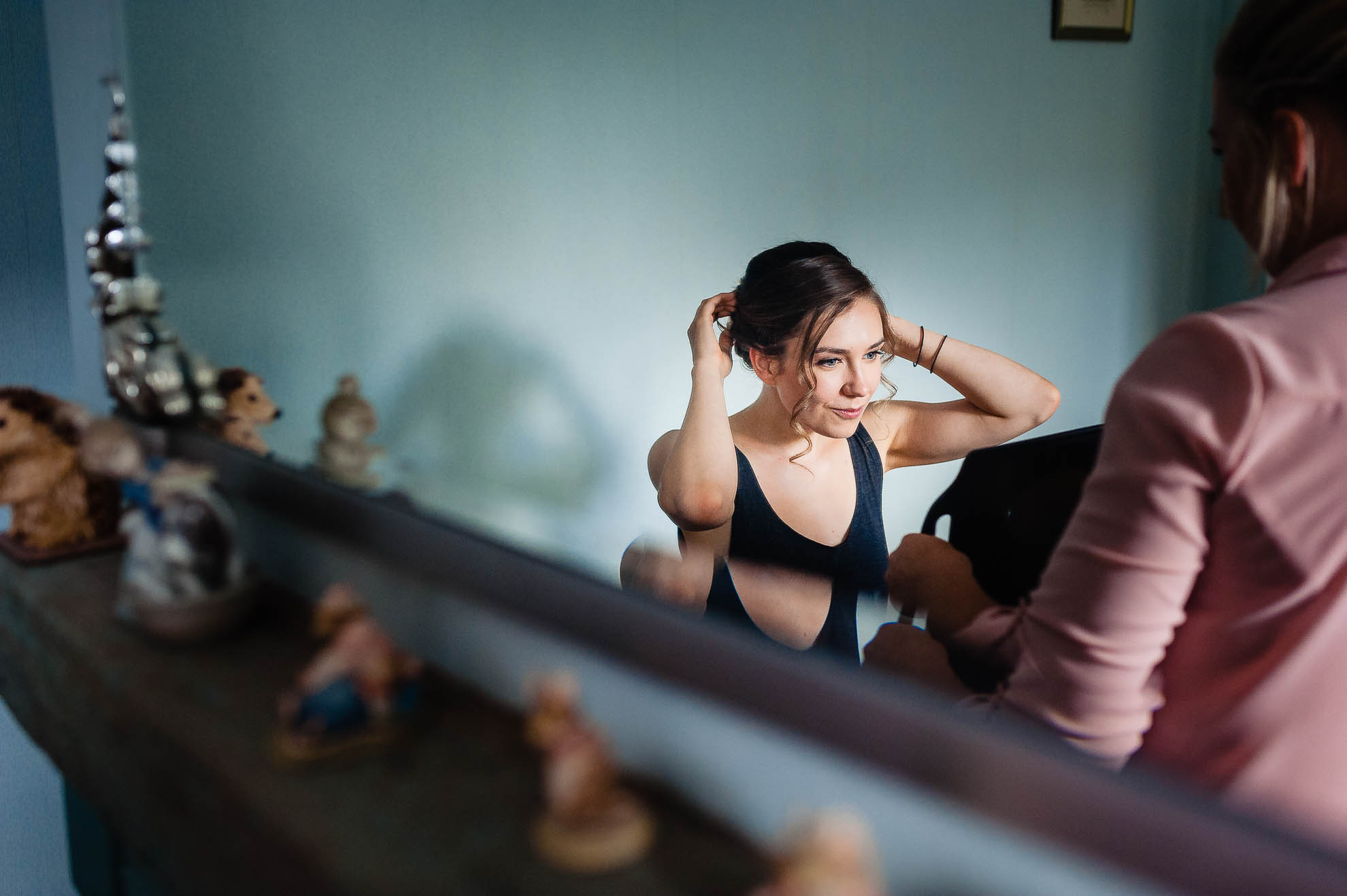 Bride adjusts her her in mirror