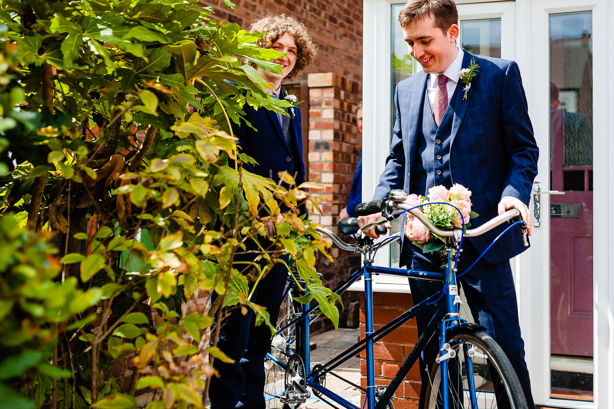 Groom and his best man with tandem cycle