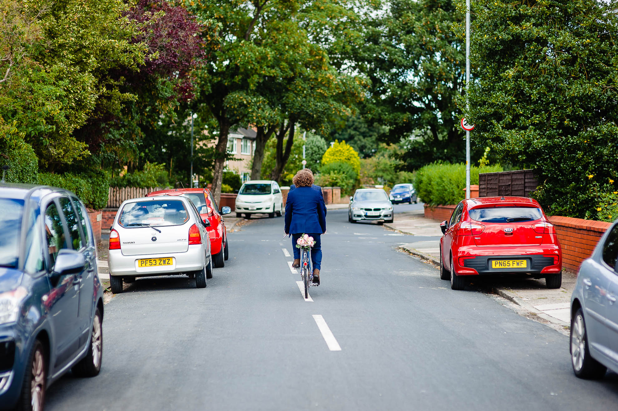Groom and best man ride tandem cycle to church