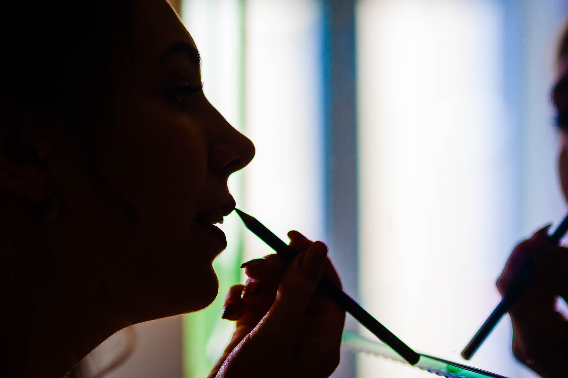 Bride silhouette applying lip stick