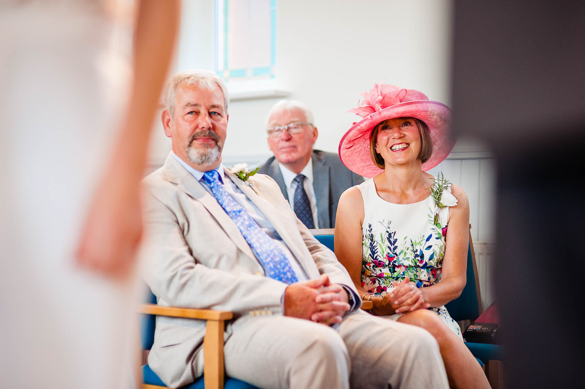 Mother of the bride smiles as she looks on 