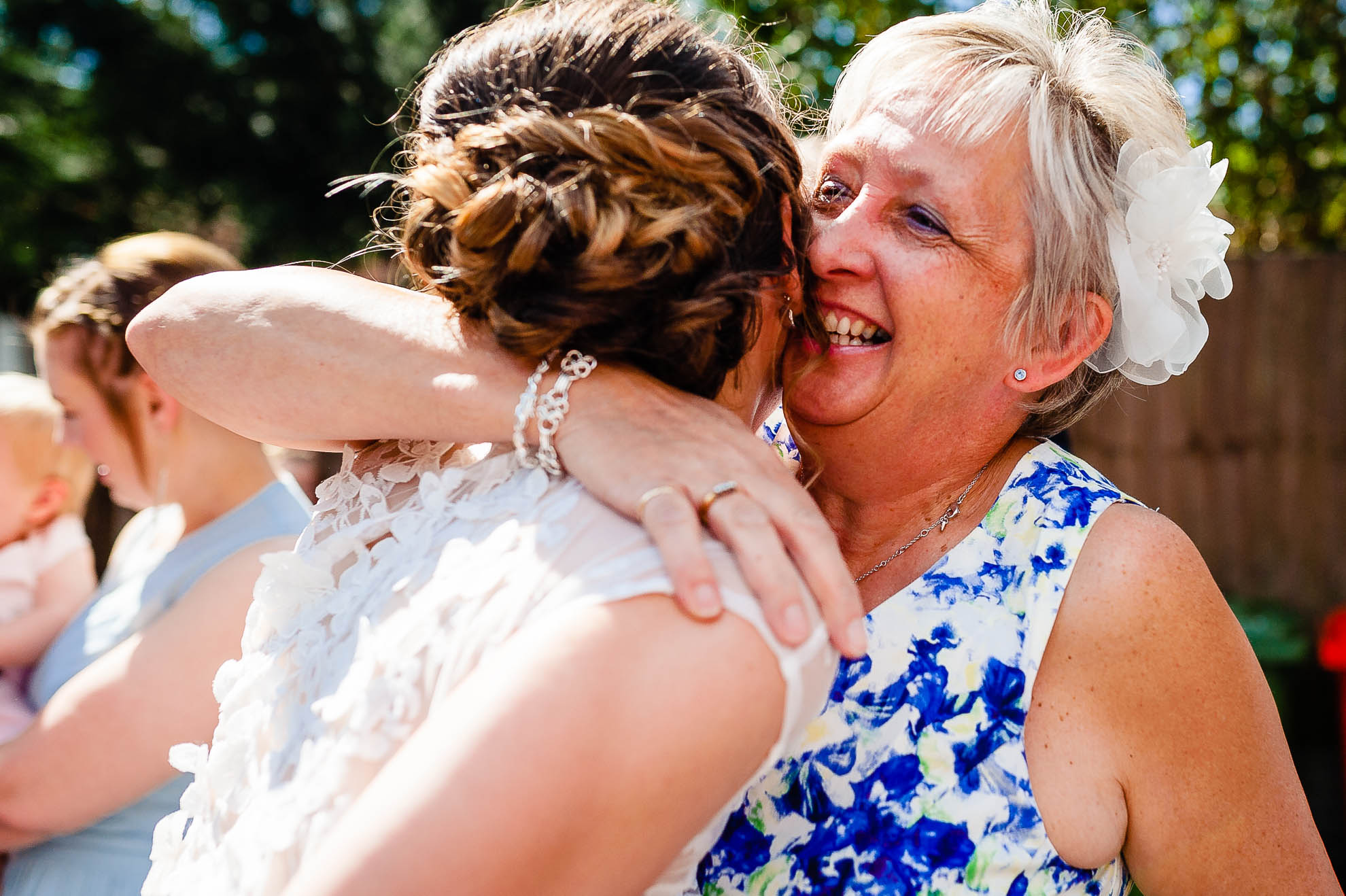Guest gives bride a big hug