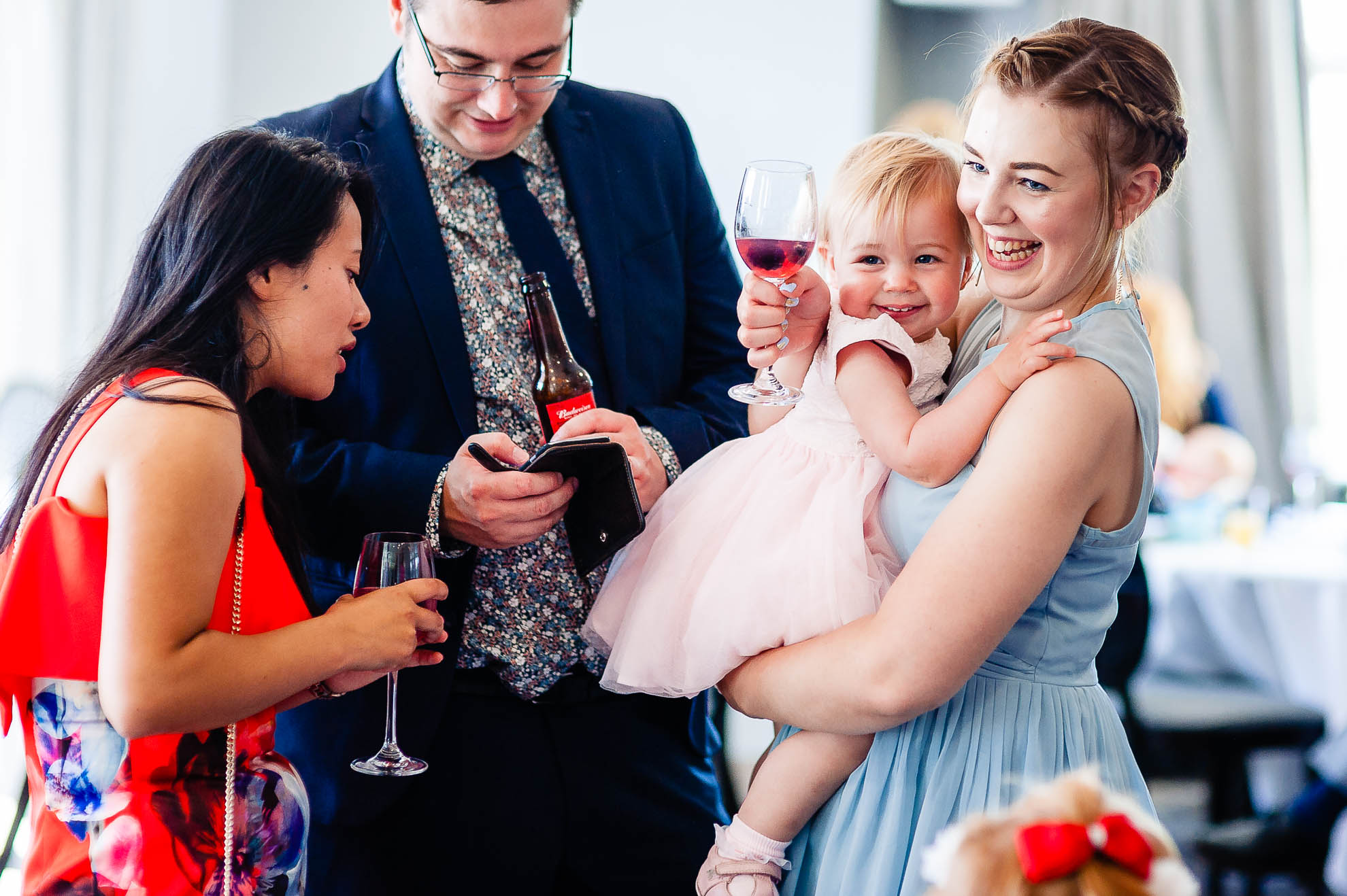 Bridesmaid and daughter share a joke
