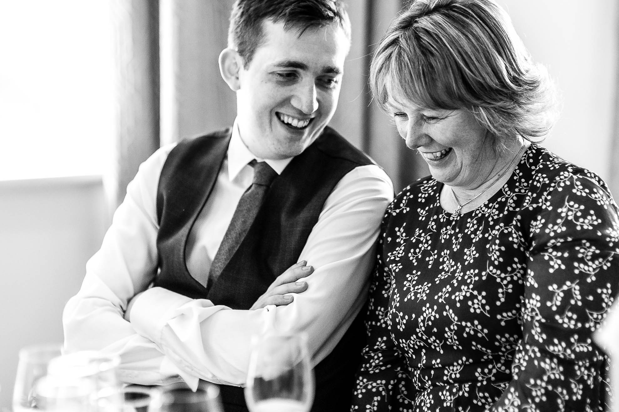 groom sharing a joke with his mother