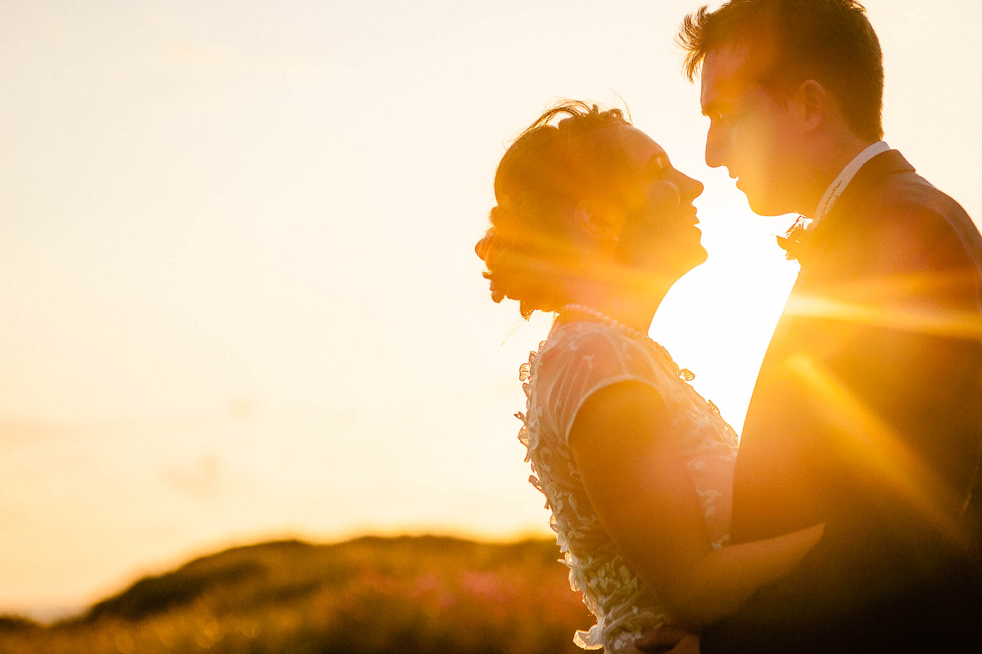 Close up of bride and groom in sunset