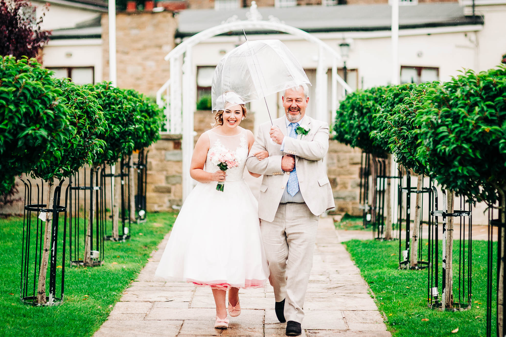 Father of the bride walks the bride to the ceremony