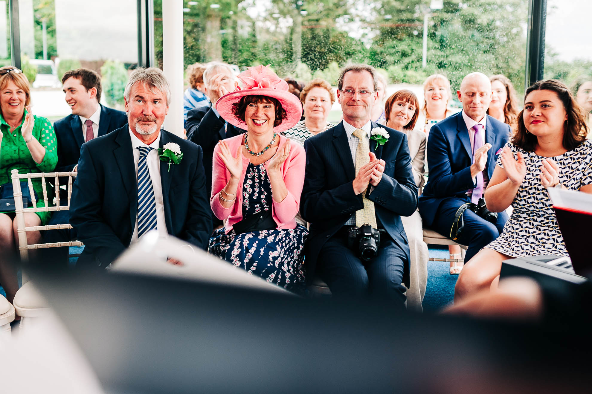 Mother of the bride and wedding guests congratulate the newly weds