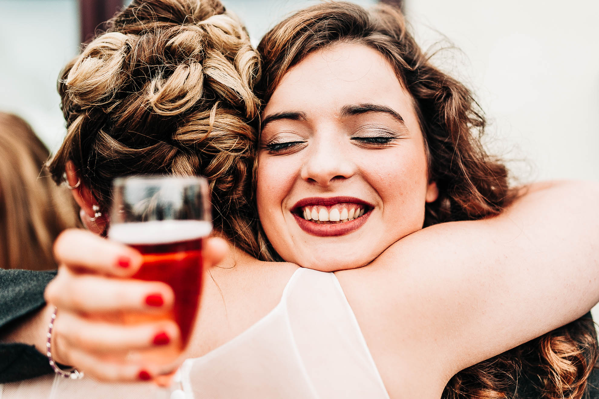 Guest hugs the bride during the reception