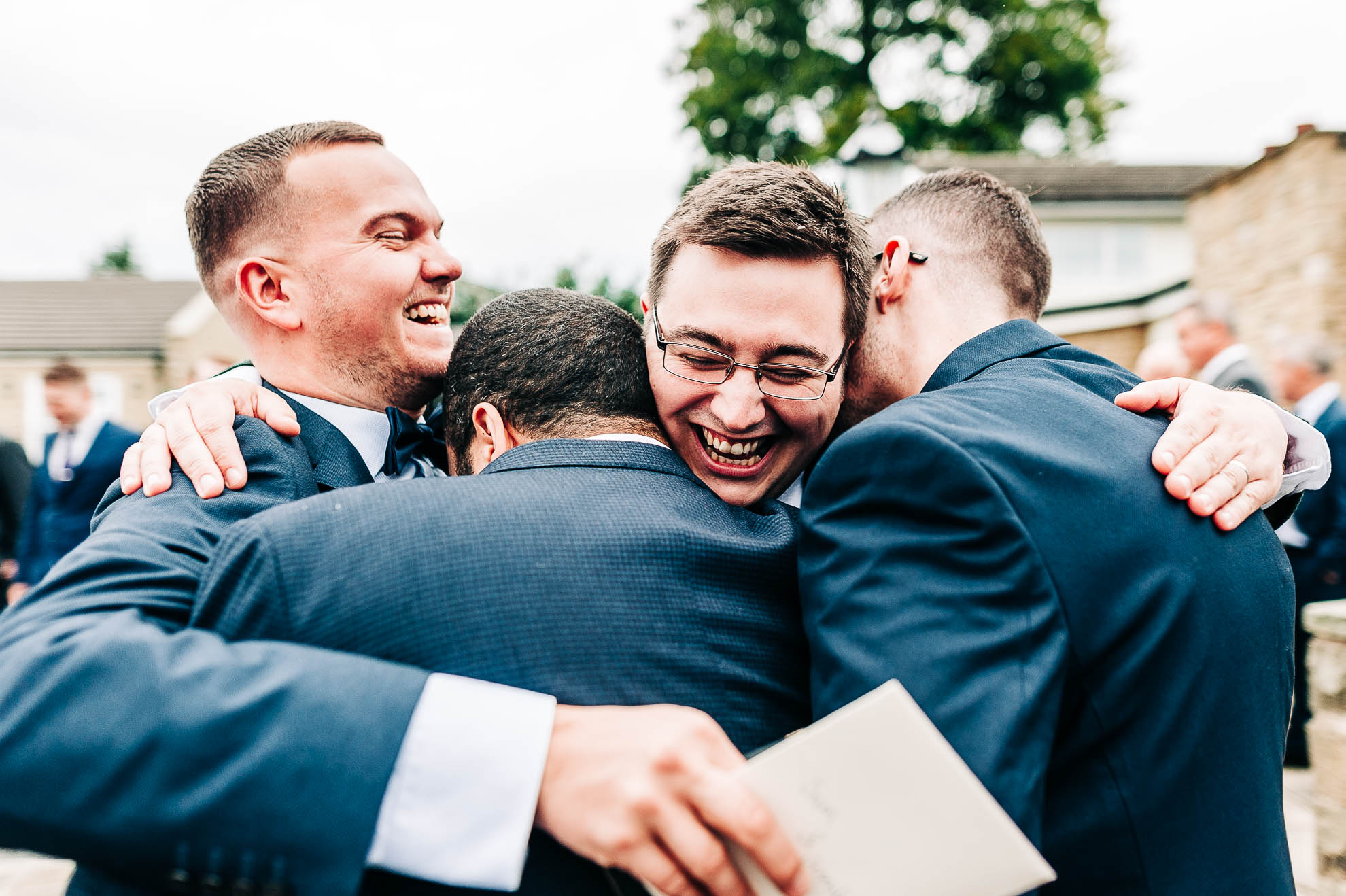 Groom hugs a few friends
