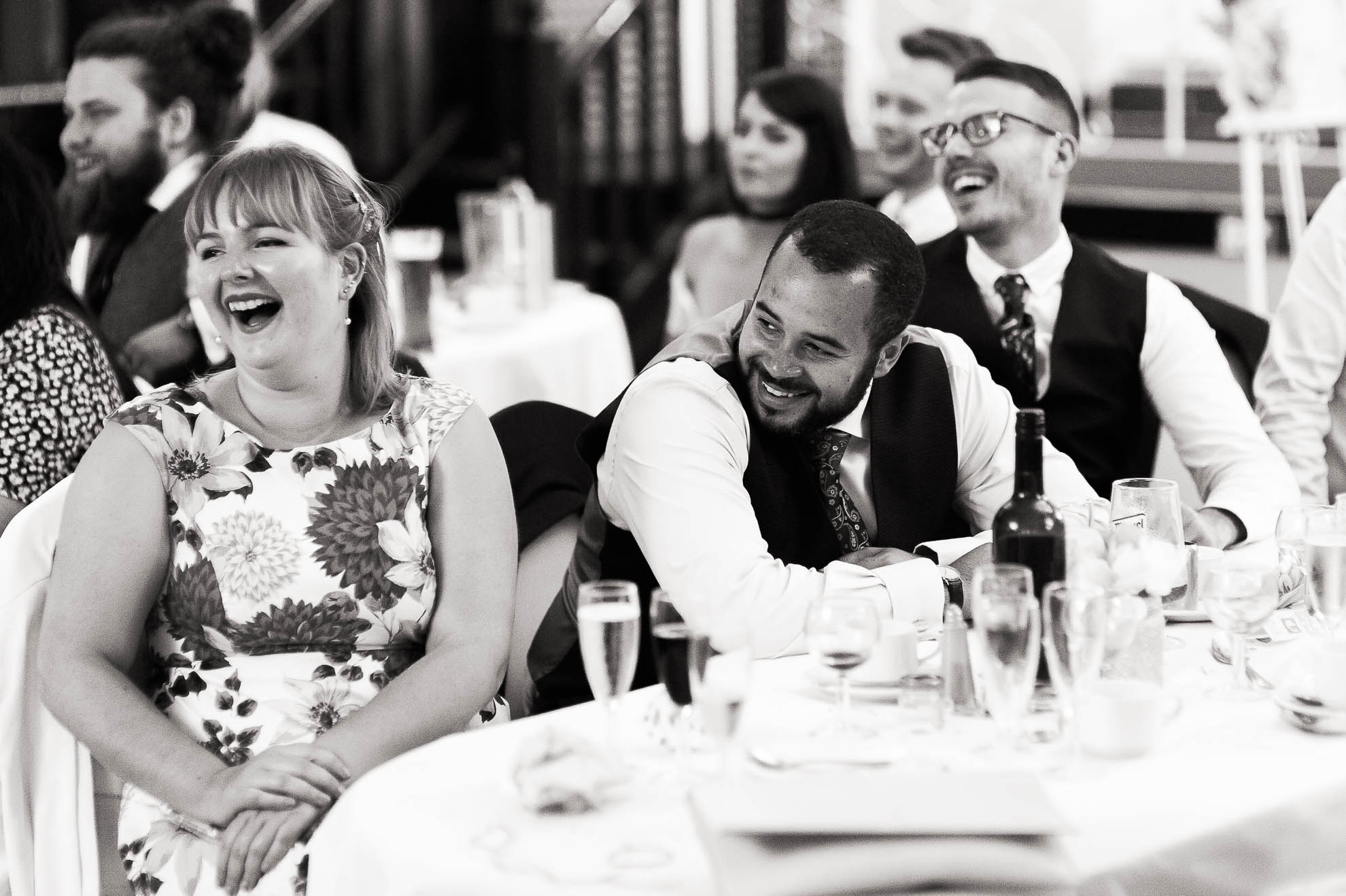 Guests laugh during the father of the bride's speech