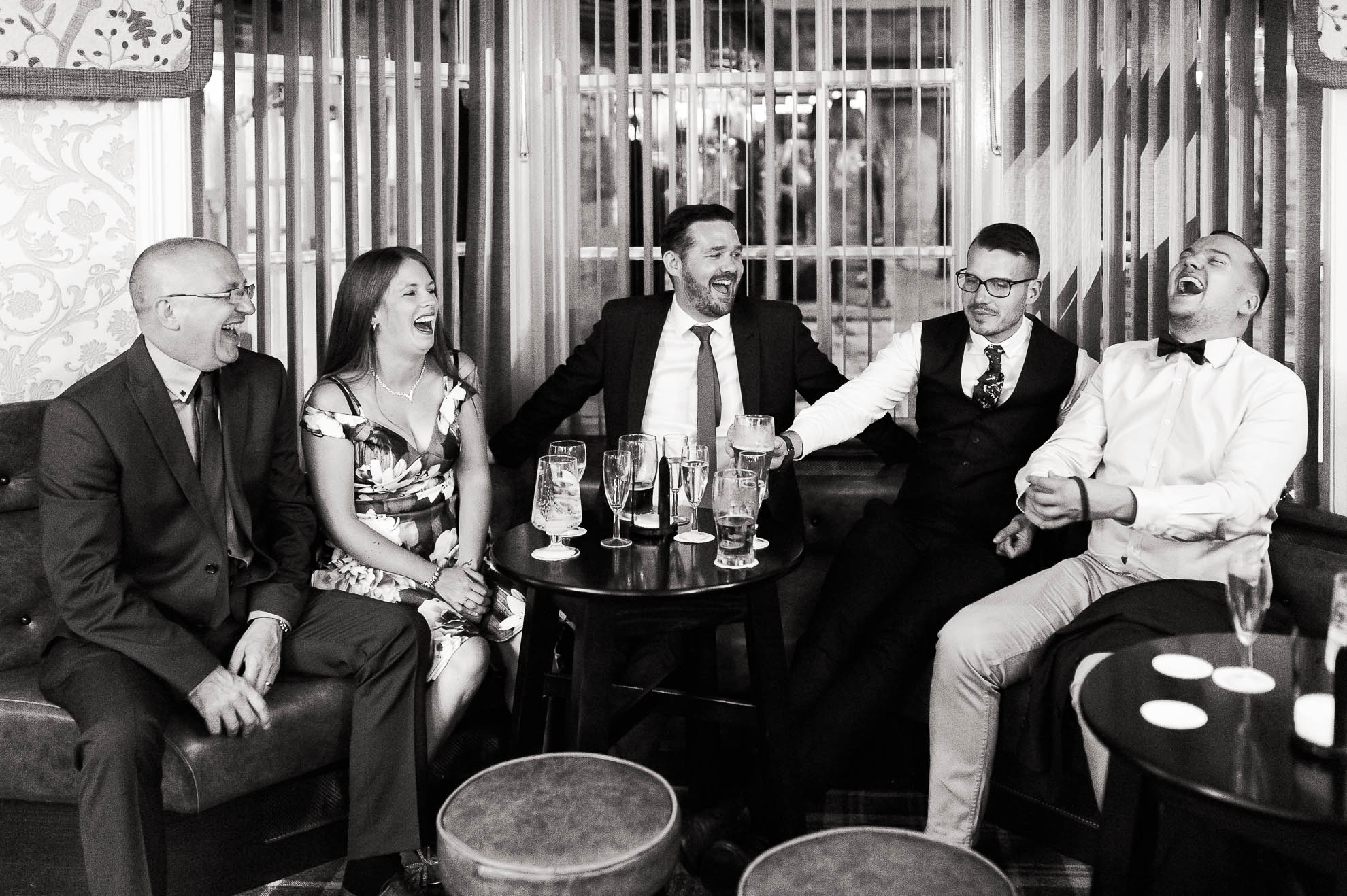 Wedding guests share a joke