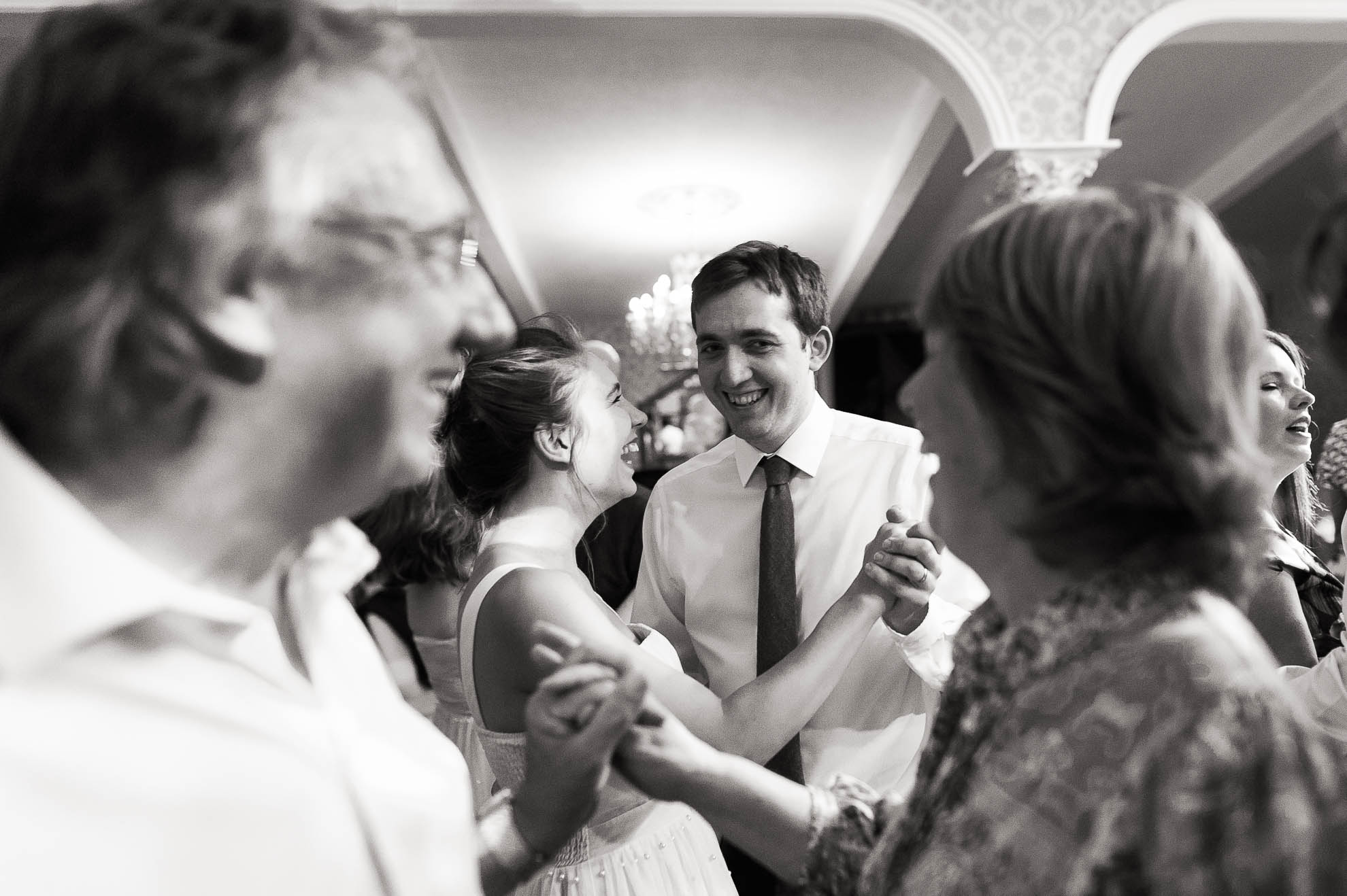 Bridesmaid and partner dancing
