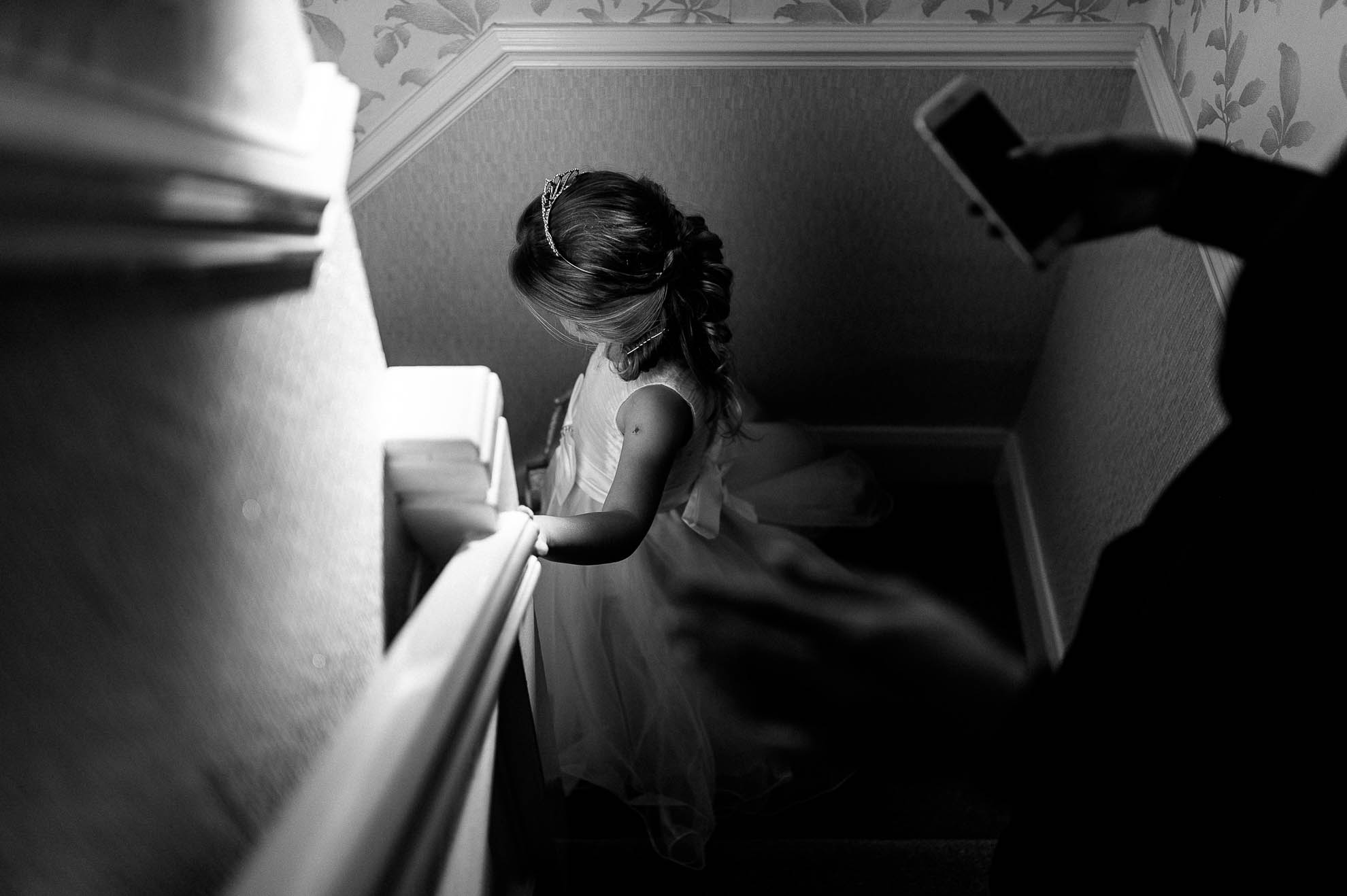 flower girl walks down stairs