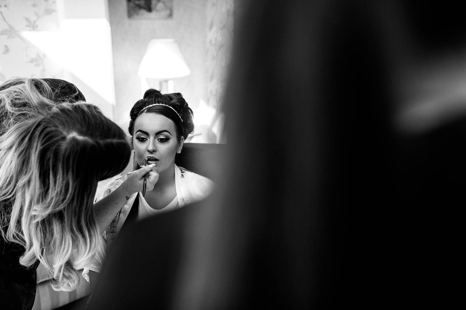 bride has lipstick applied