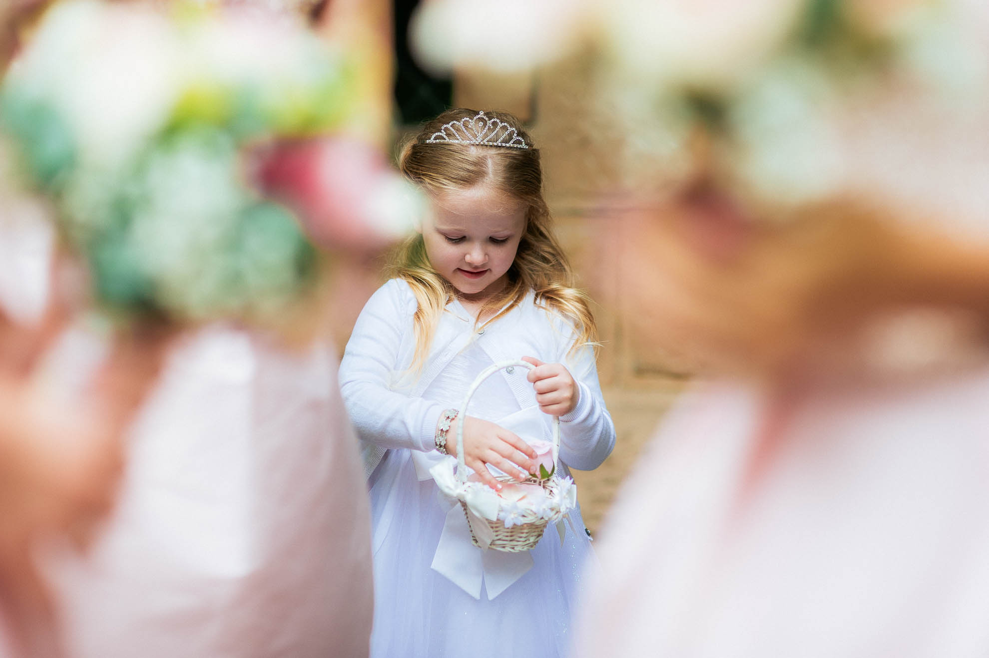 flower girl is very pleased with her flower petals