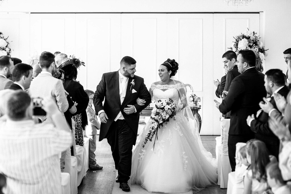 bride and groom walk back down the aisle