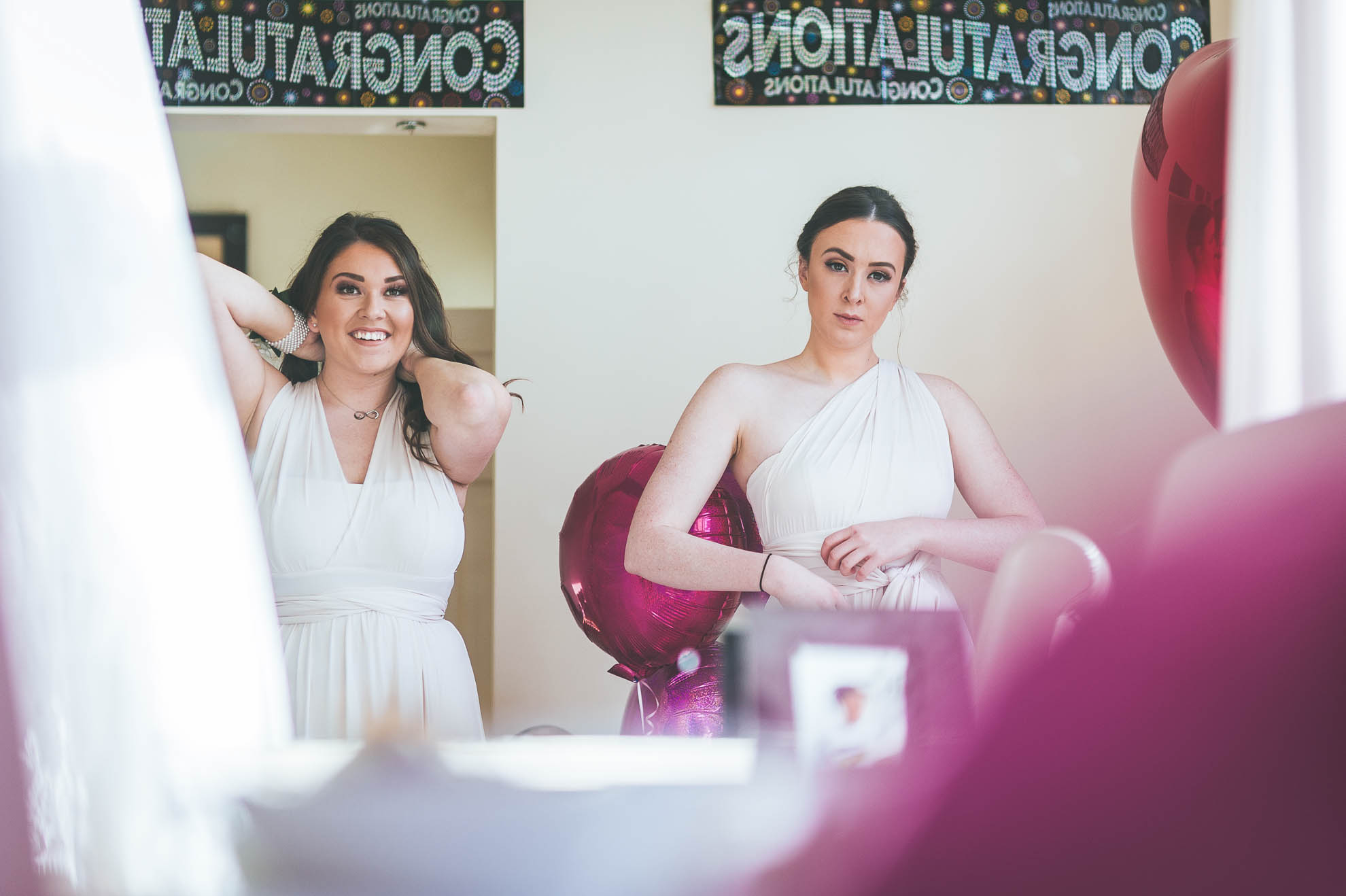 Bridesmaids put their dresses on during bridal preparations