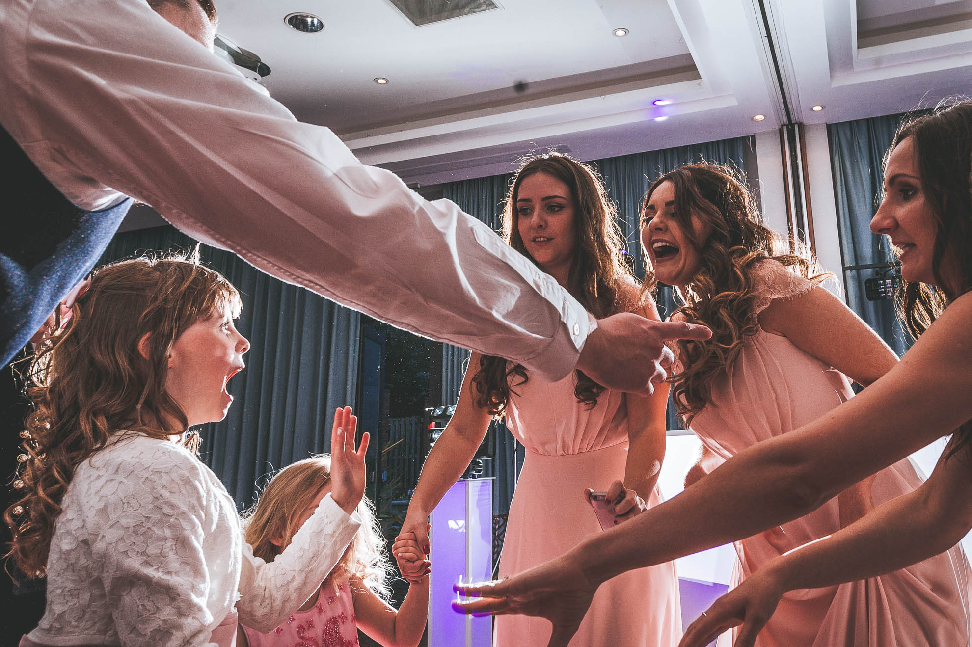 Flower girl and bridesmaids dance during the first dance