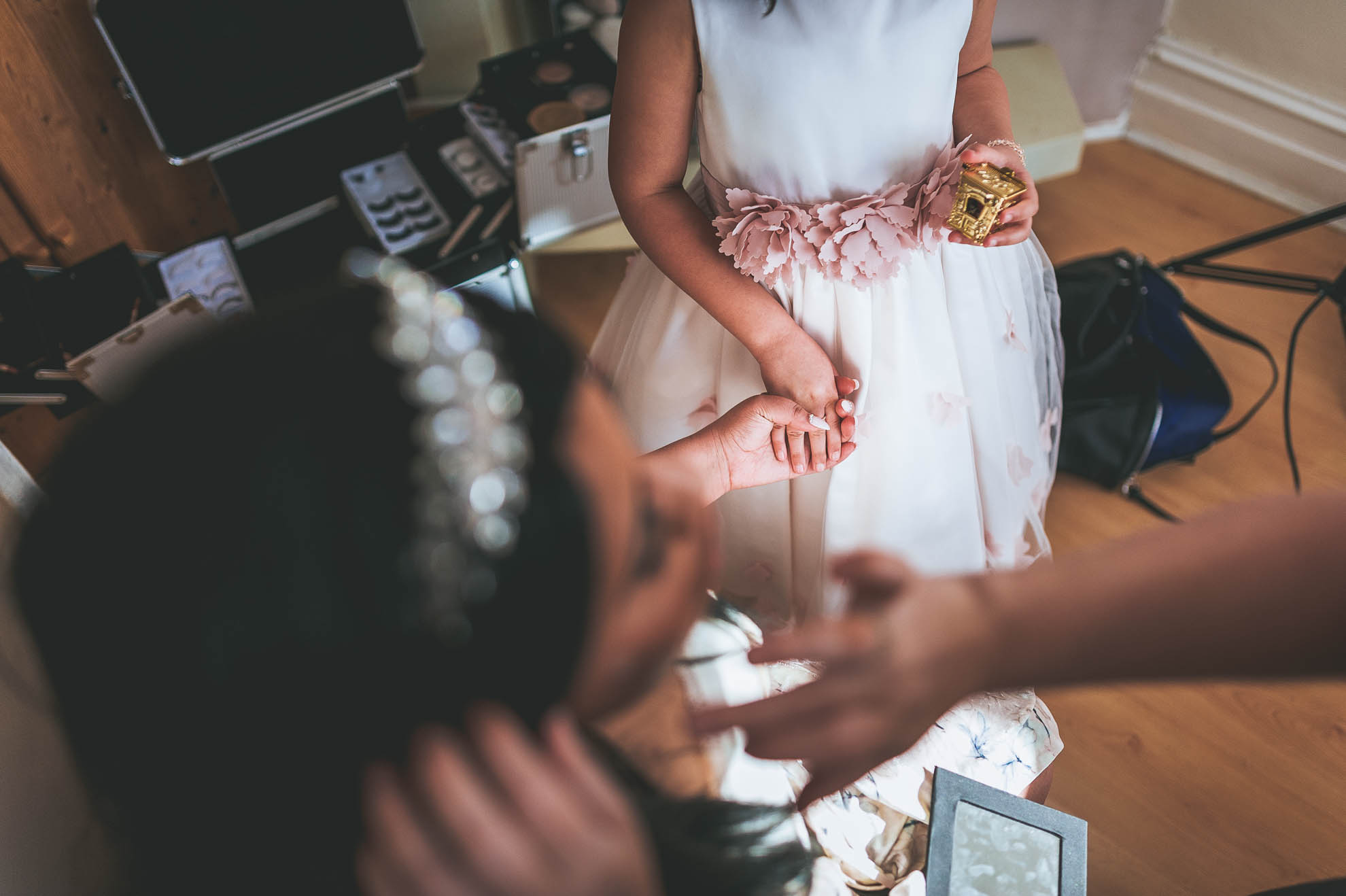 bride and flower girl holding hands