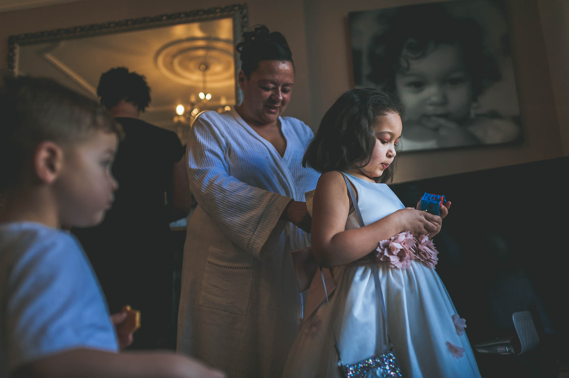 flower girl having her dress put on