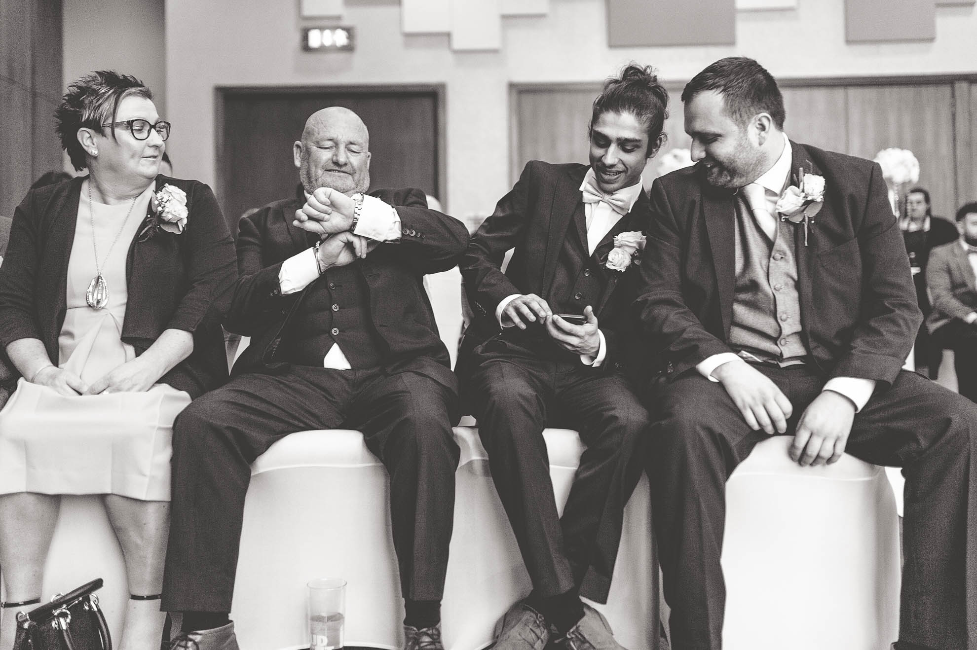 grooms mum and dad share a joke