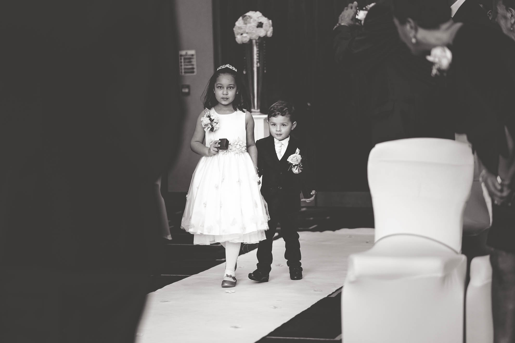 flower girl and page boy walk up aisle