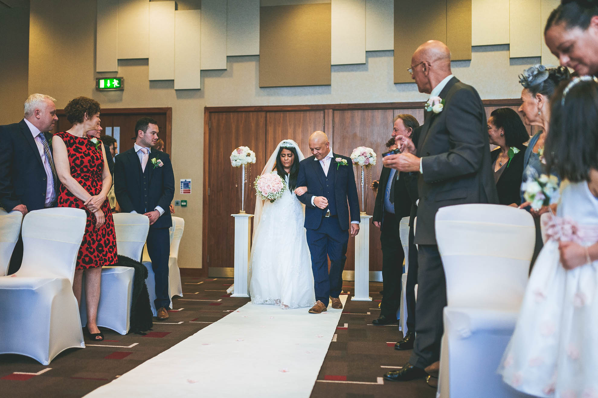 bride walks up aisle with father of the bride