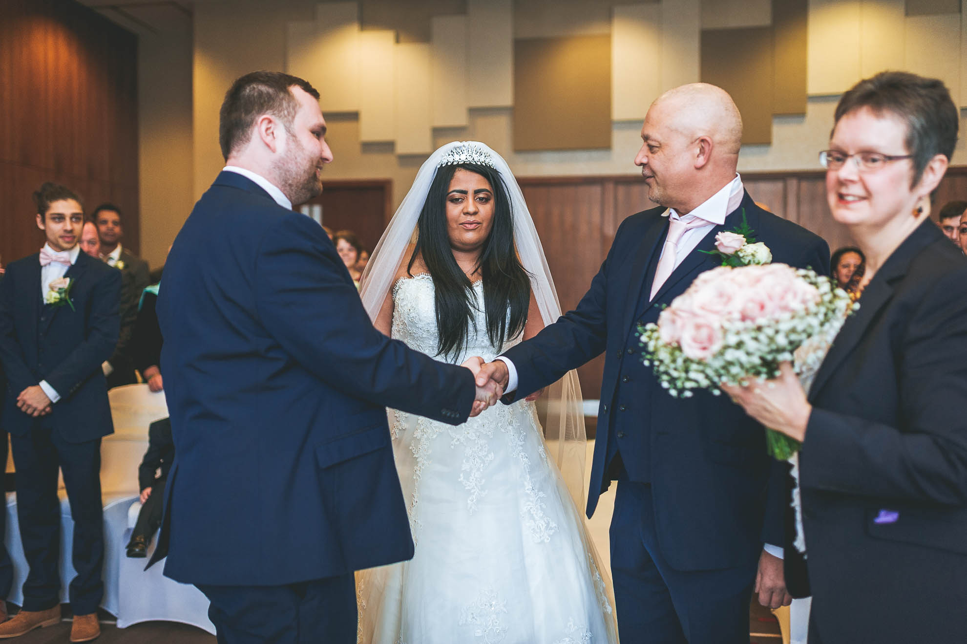 father of the bride shakes grooms hand