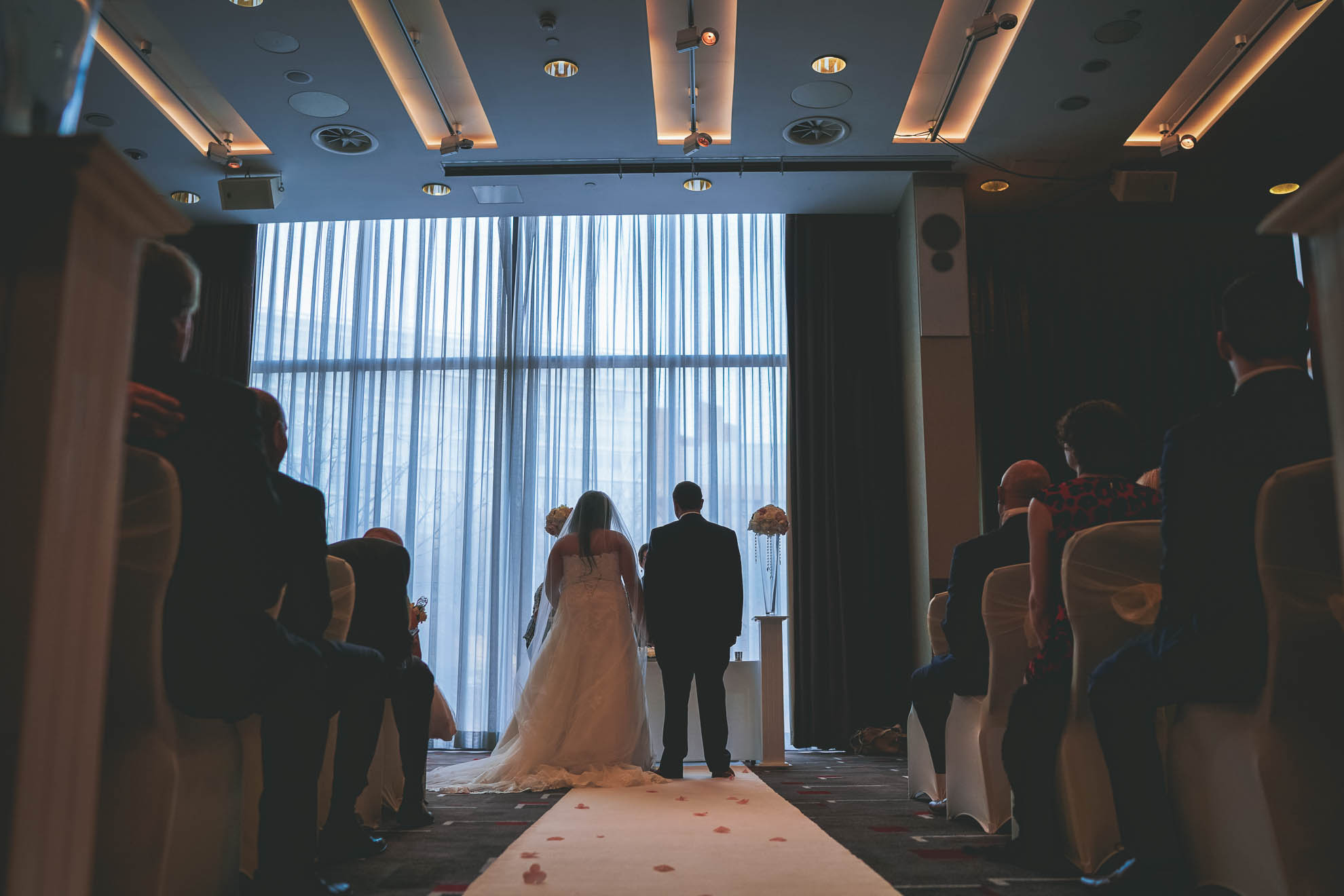view of bride and groom from back of the ceremony room