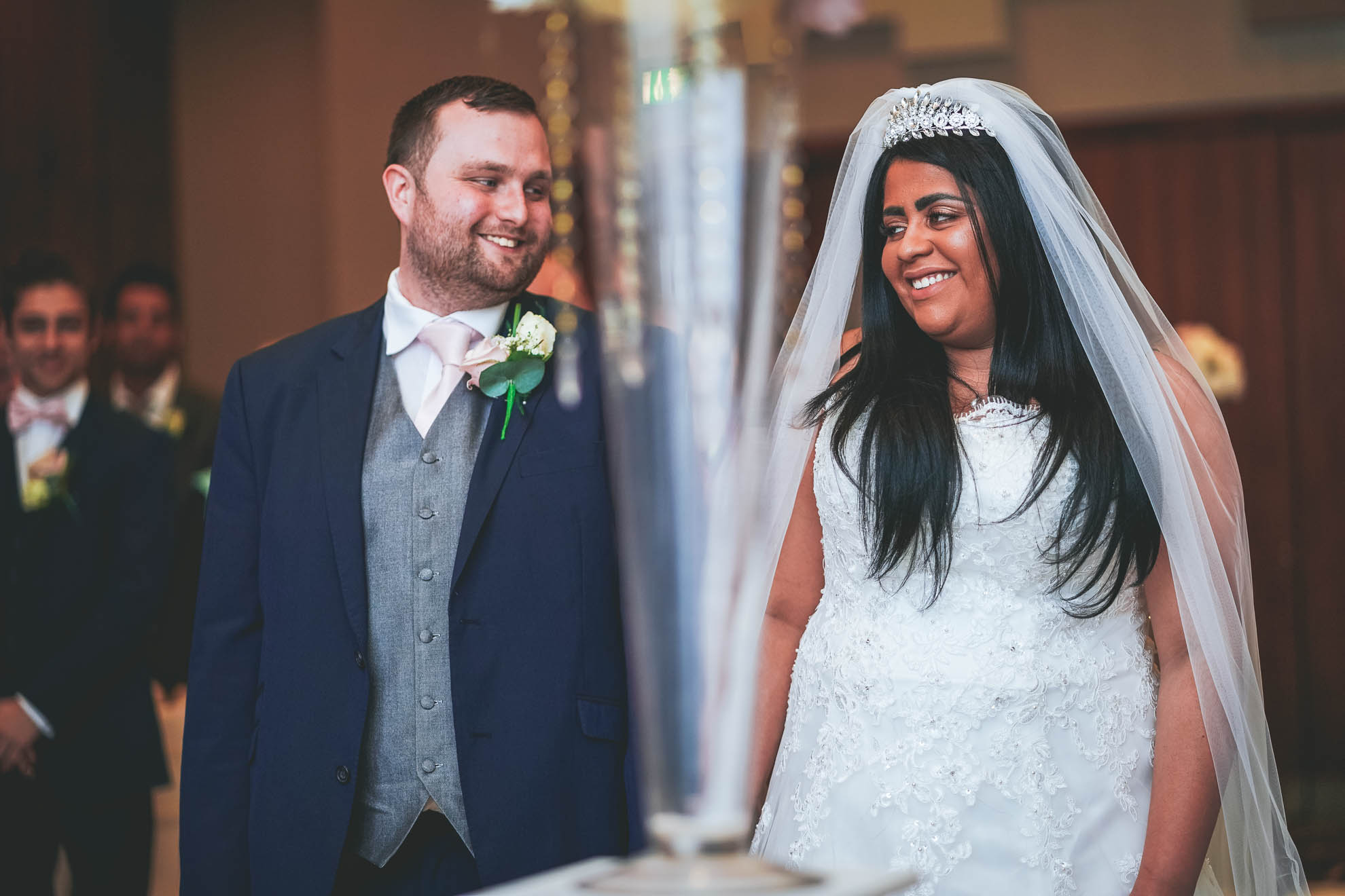 bride and groom smile at each other