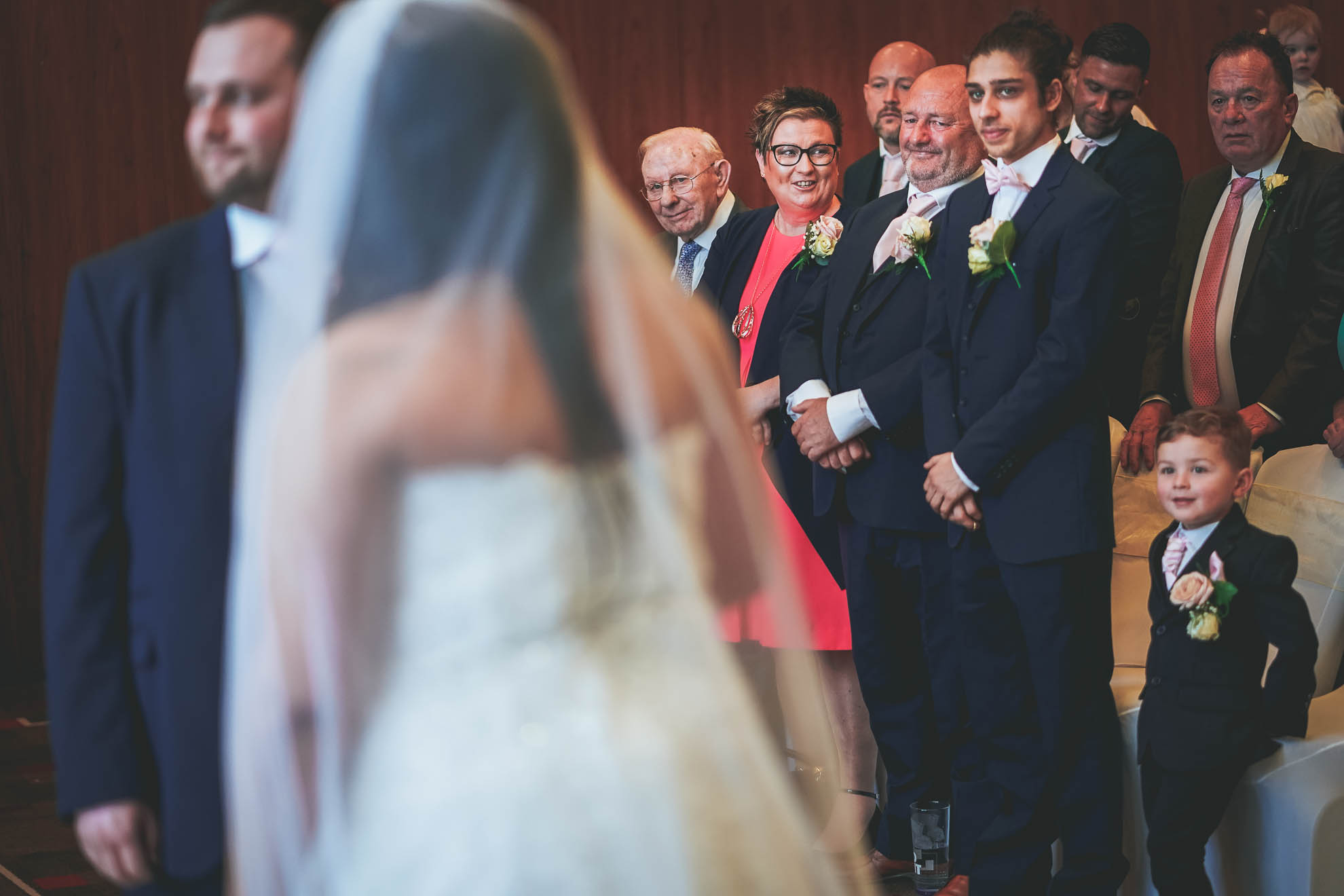 grooms family smile as the look on